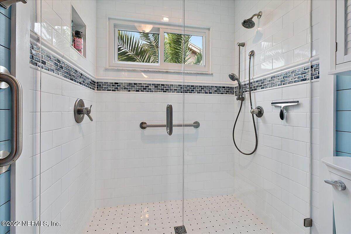 1921 Seminole Road Atlantic Beach, FL 32233 - Photo 16 of 27 a bathroom with a granite countertop shower a sink and a window
