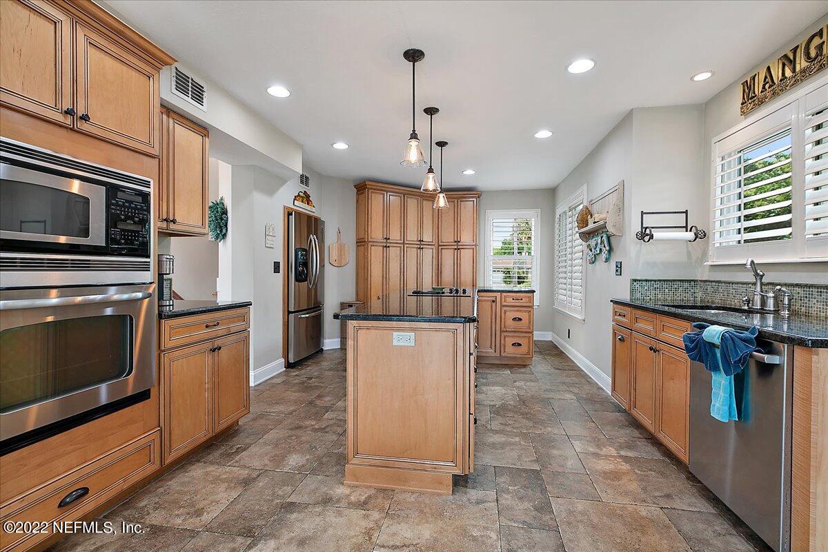 1921 Seminole Road Atlantic Beach, FL 32233 - Photo 4 of 27 a large kitchen with stainless steel appliances kitchen island granite countertop a stove refrigerator a oven and a microwave