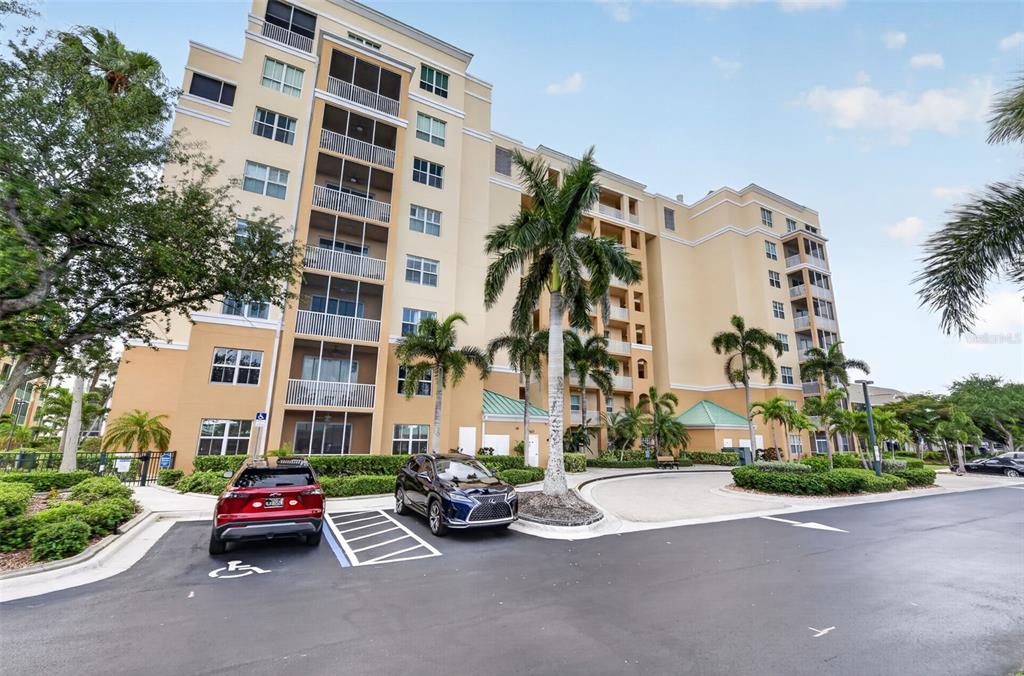2060 Matecumbe Key Road, Unit 2506 Punta Gorda, FL 33955 - Photo 35 of 38 a car parked in front of a building and cars parked