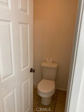 a white toilet sitting next to a shower