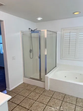 a bathroom with a bathtub and a shower