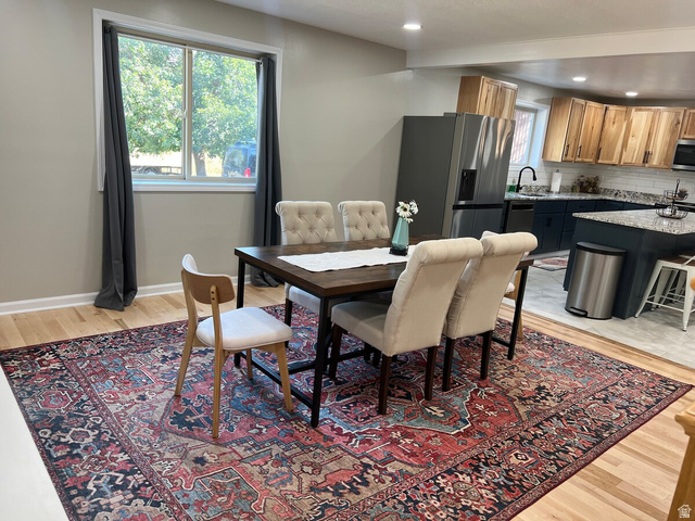 2807 North Ogden Canyon Road Eden, UT 84310 - Photo 15 of 72 Open-concept dining area featuring wood-finish flooring, a contemporary window, recessed lighting, and direct access to the kitchen