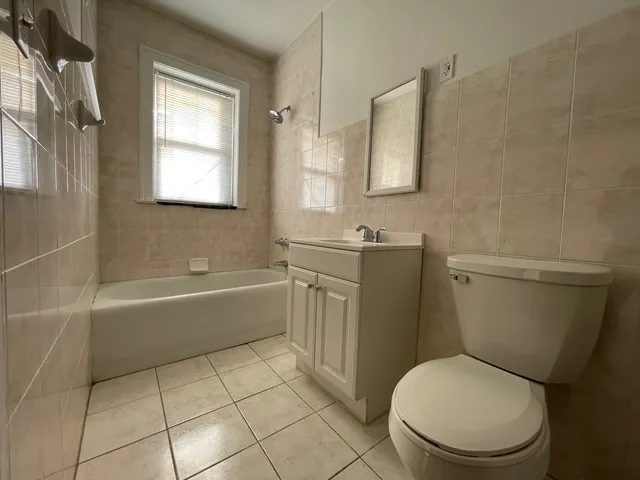 a bathroom with a toilet a sink and bathtub