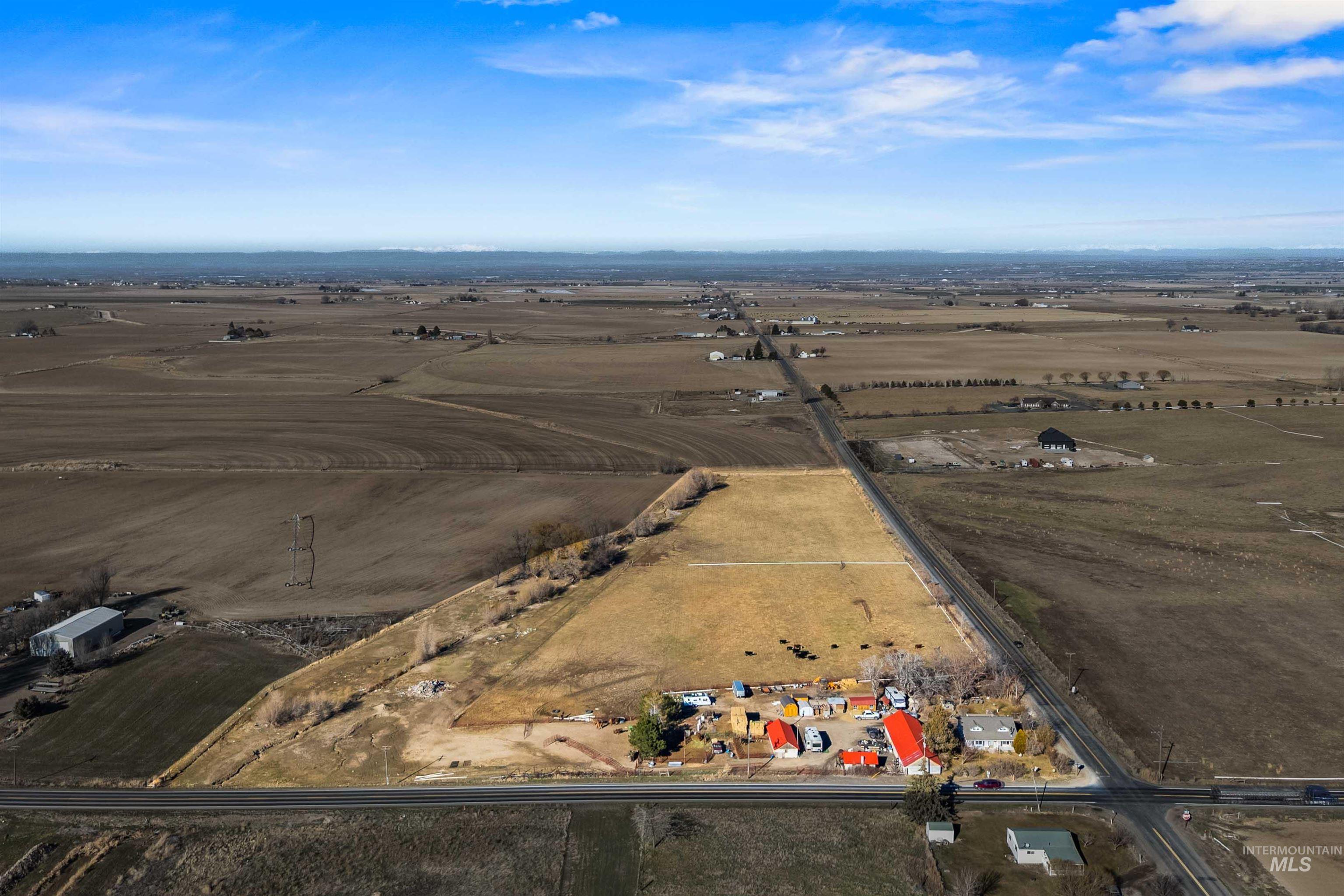Aerial view of property and surrounding area with rural landscape