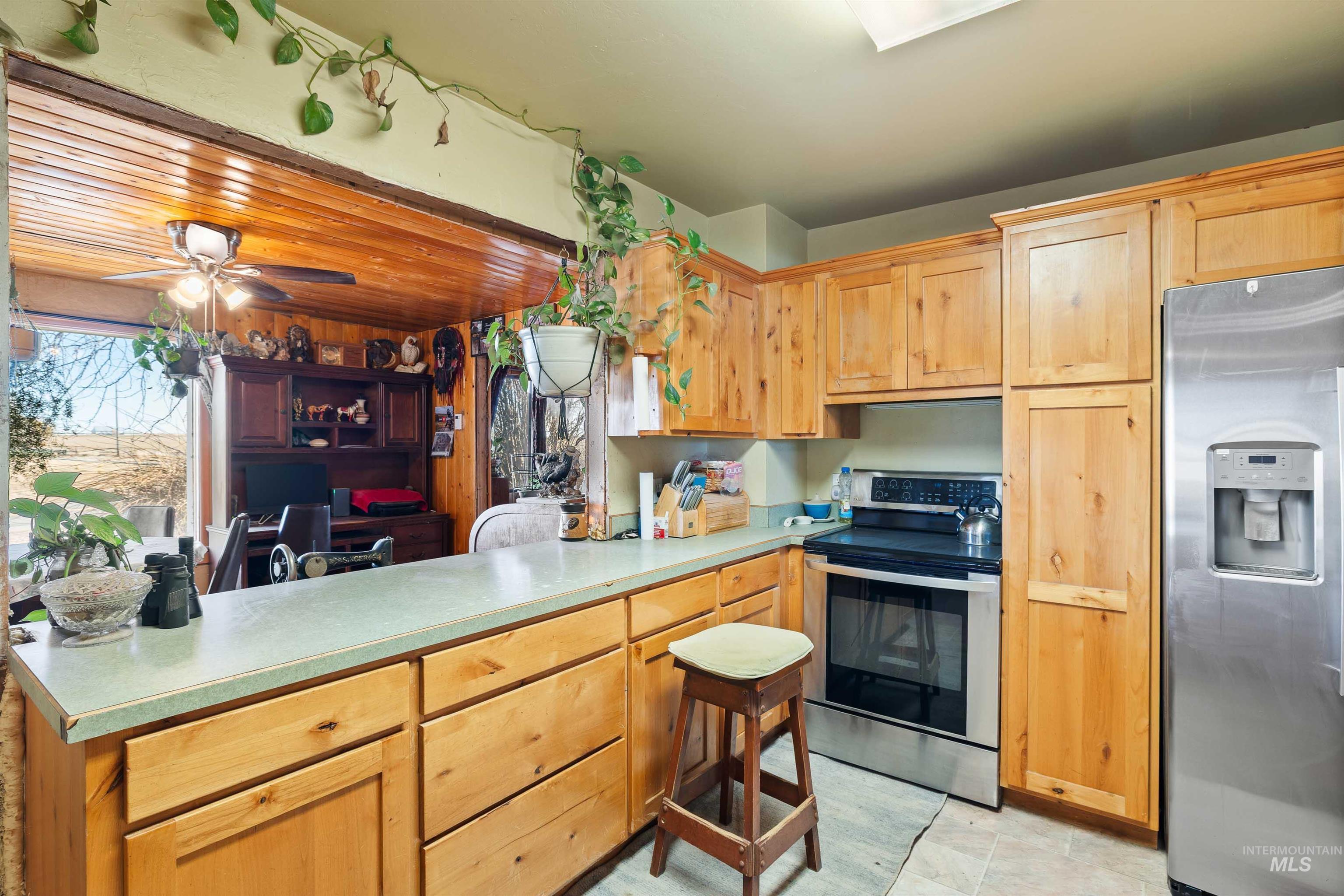 1898 East 3700th Street North Filer, ID 83328 - Photo 11 of 40 Kitchen with stainless steel appliances, light countertops, light wood finish cabinetry, and healthy amount of natural light