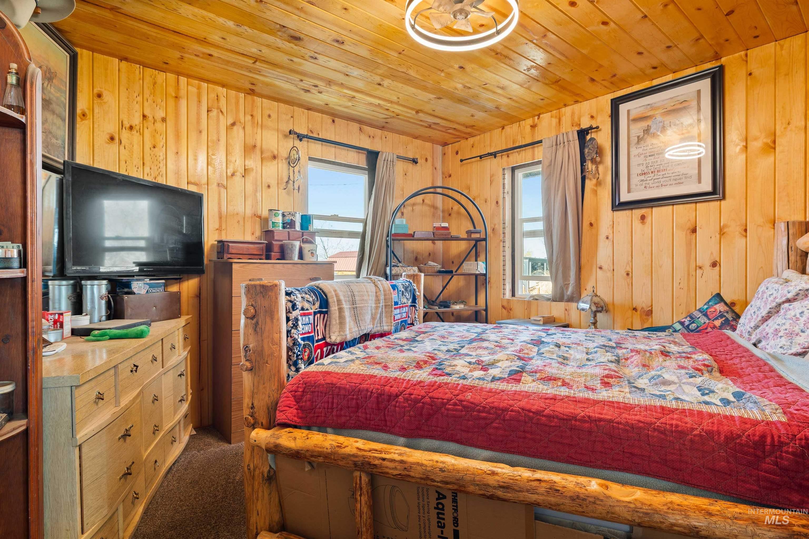 1898 East 3700th Street North Filer, ID 83328 - Photo 13 of 40 Carpeted bedroom with wooden walls and wood ceiling