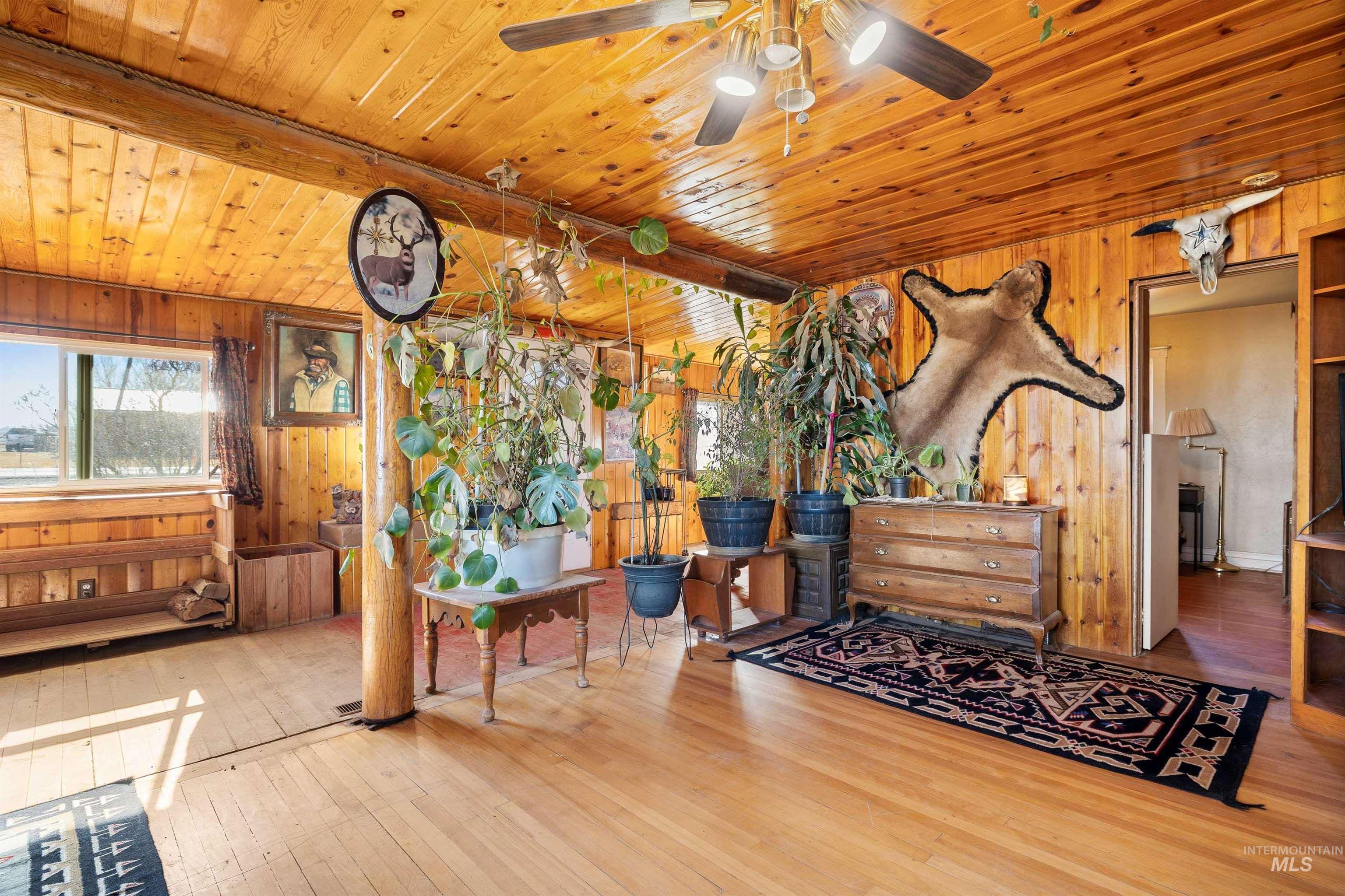 1898 East 3700th Street North Filer, ID 83328 - Photo 2 of 40 Bedroom featuring wood walls, hardwood / wood-style floors, and a wood ceiling with exposed beams