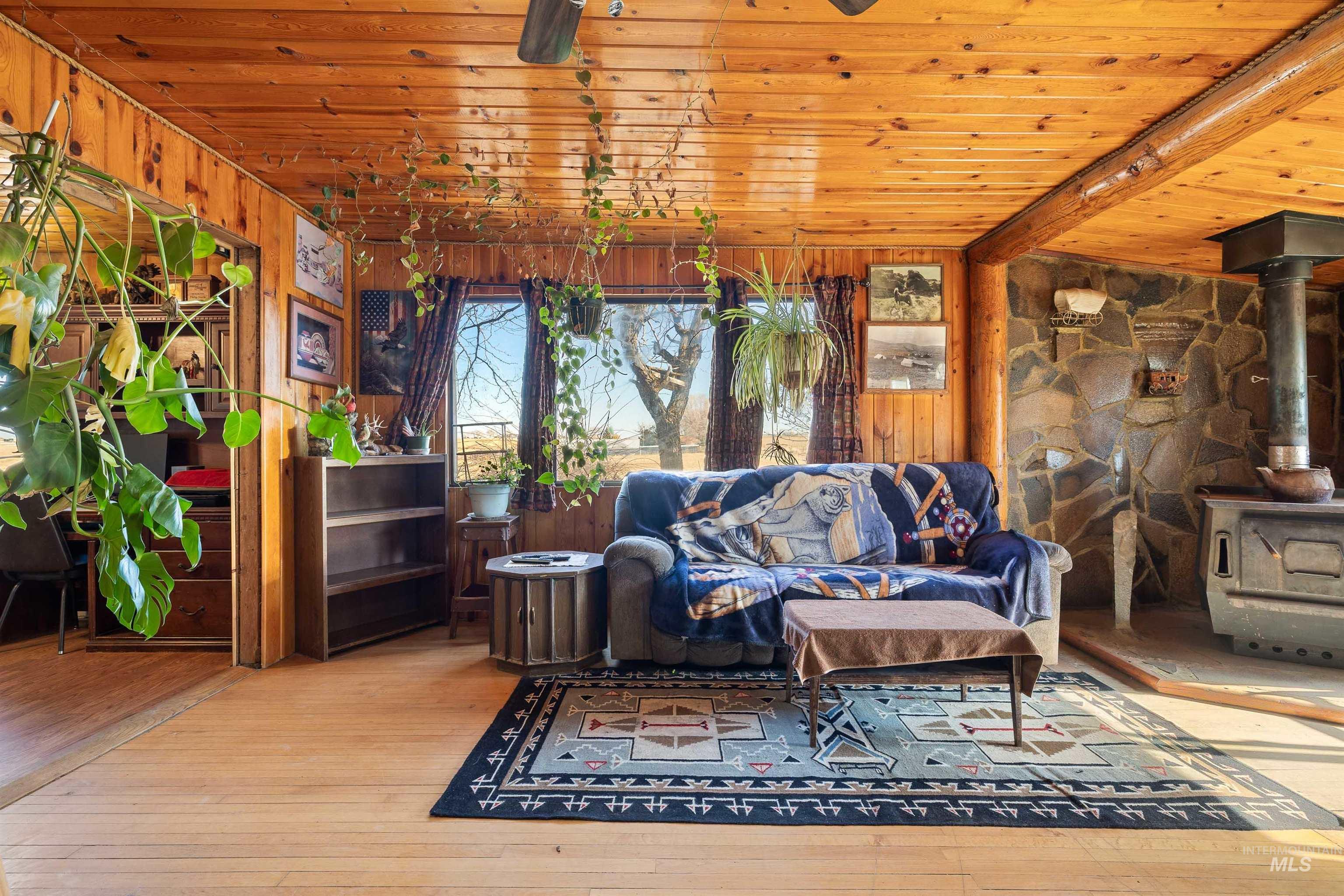 1898 East 3700th Street North Filer, ID 83328 - Photo 3 of 40 Sunroom / solarium featuring a wood stove and beamed ceiling