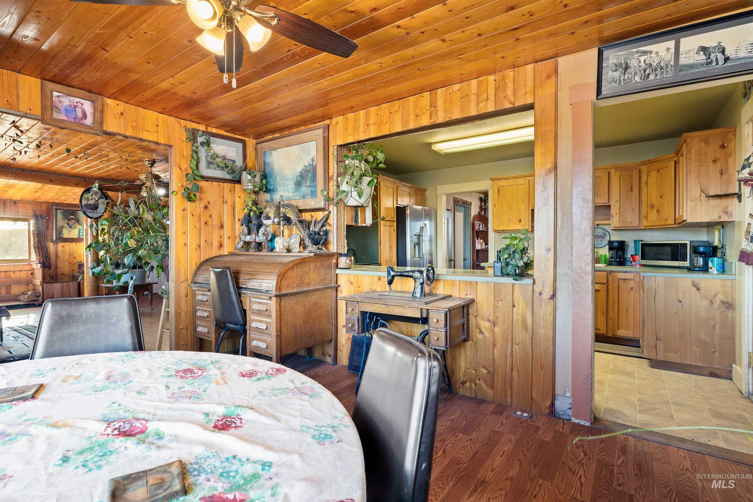 1898 East 3700th Street North Filer, ID 83328 - Photo 8 of 40 Dining room with a ceiling fan, wood ceiling, and dark wood finished floors