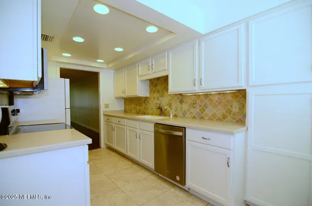 a kitchen with stainless steel appliances wooden cabinets and a stove top oven