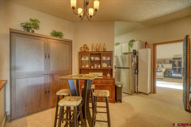 a view of a dining room with furniture and chandelier