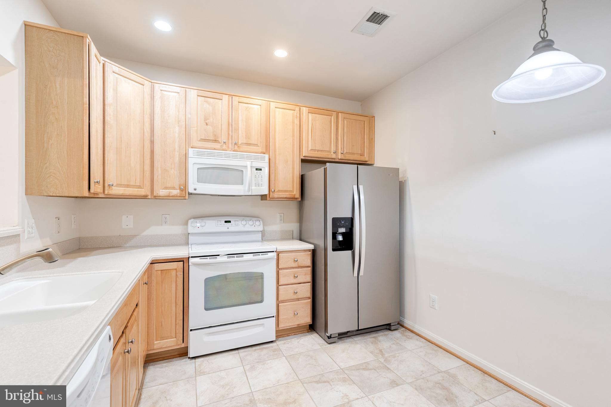 7305 Brookview Road, Unit 308 Elkridge, MD 21075 - Photo 9 of 25 New stainless steel refrigerator in kitchen