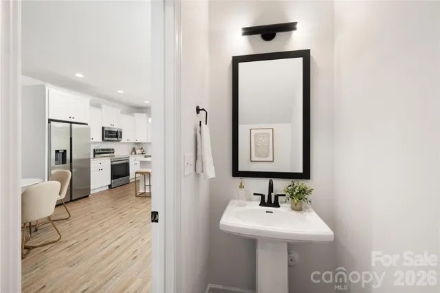 a bathroom with a sink a mirror and a shower