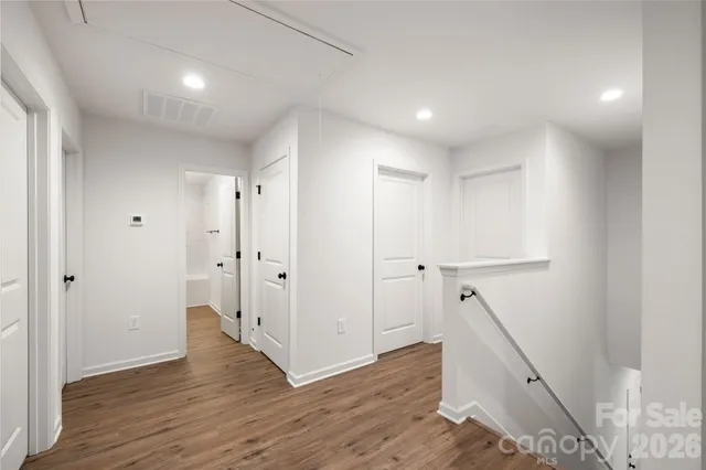 a view of hallway with wooden floor
