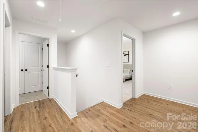 a view of hallway with wooden floor