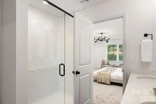 a bedroom with a bed table and a window