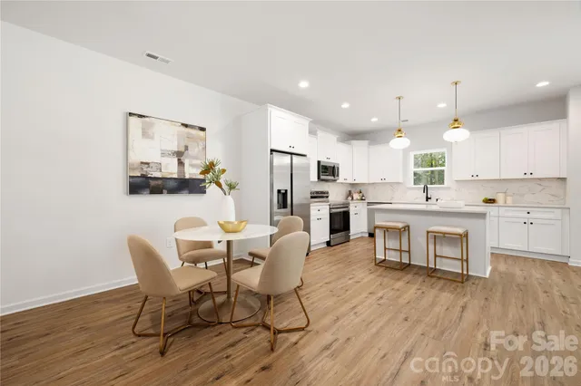 a kitchen with kitchen island wooden cabinets and stainless steel appliances