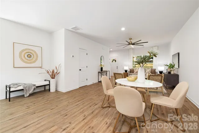 a dining room with furniture and wooden floor