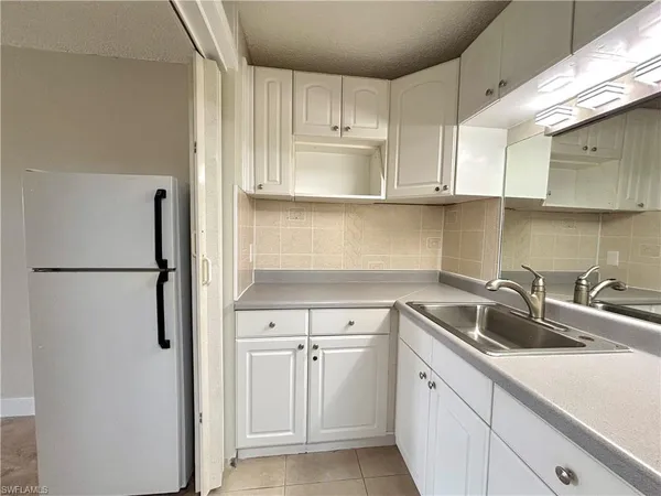 a kitchen with a sink and refrigerator
