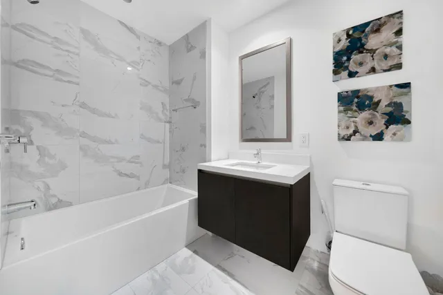 a bathroom with a sink toilet and bathtub