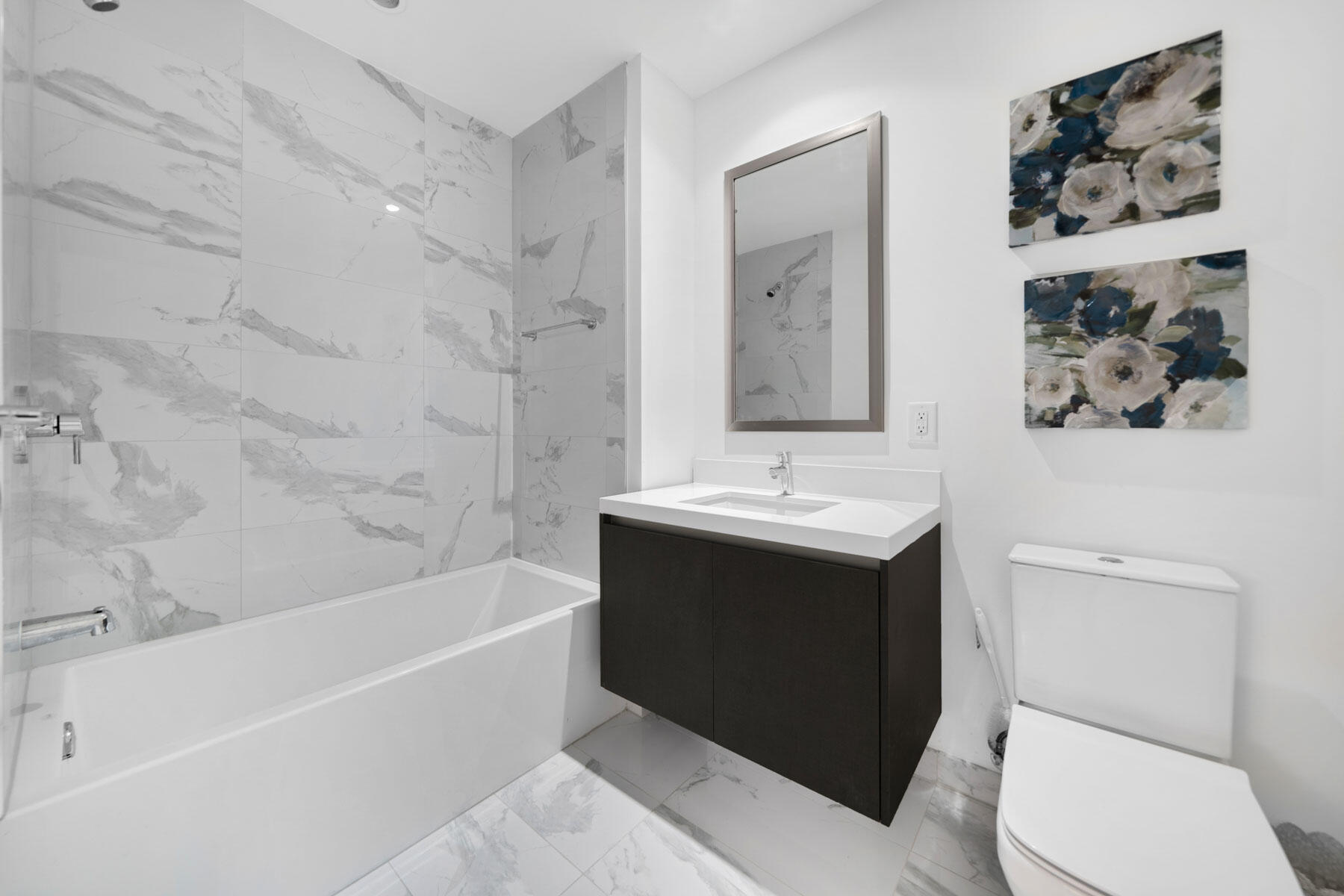 851 Northeast 1st Avenue, Unit 2410 Miami, FL 33132 - Photo 13 of 27 a bathroom with a sink toilet and bathtub