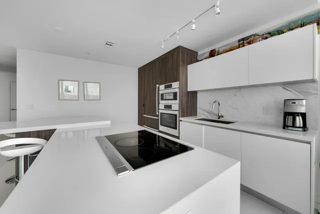 a kitchen that has a sink and a stove in it