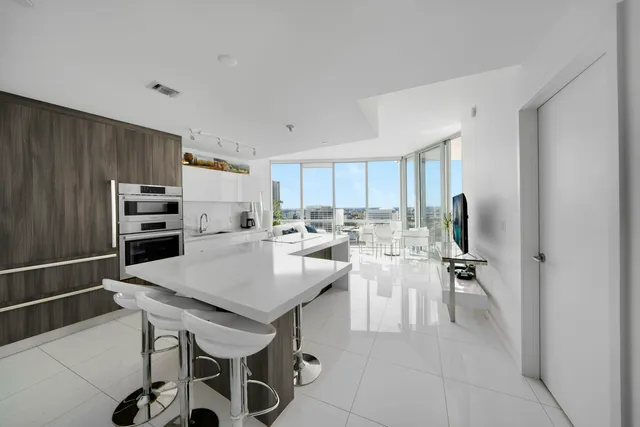 a kitchen with a table chairs refrigerator and cabinets