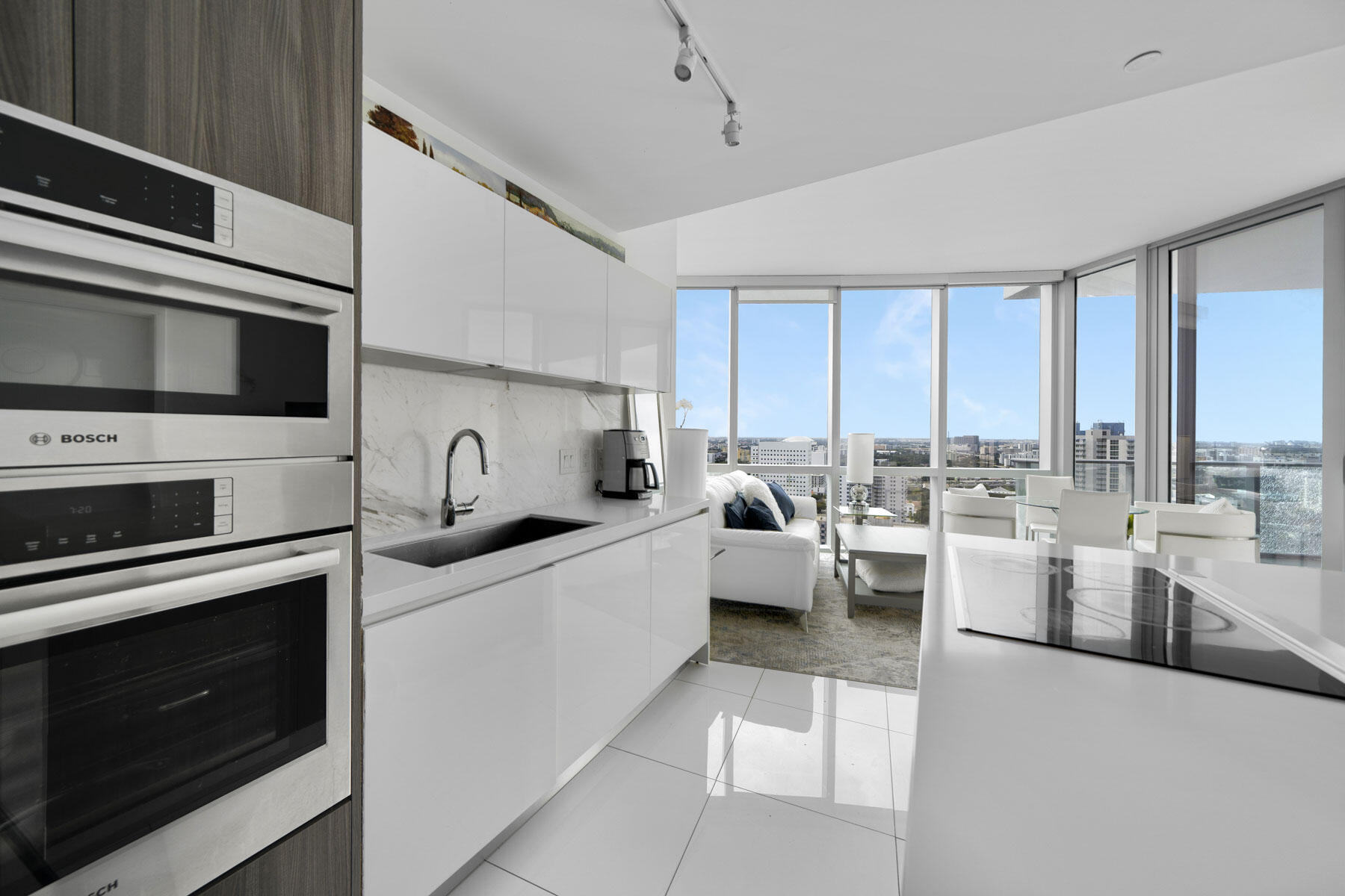 851 Northeast 1st Avenue, Unit 2410 Miami, FL 33132 - Photo 5 of 27 a kitchen with a stove a sink and a microwave