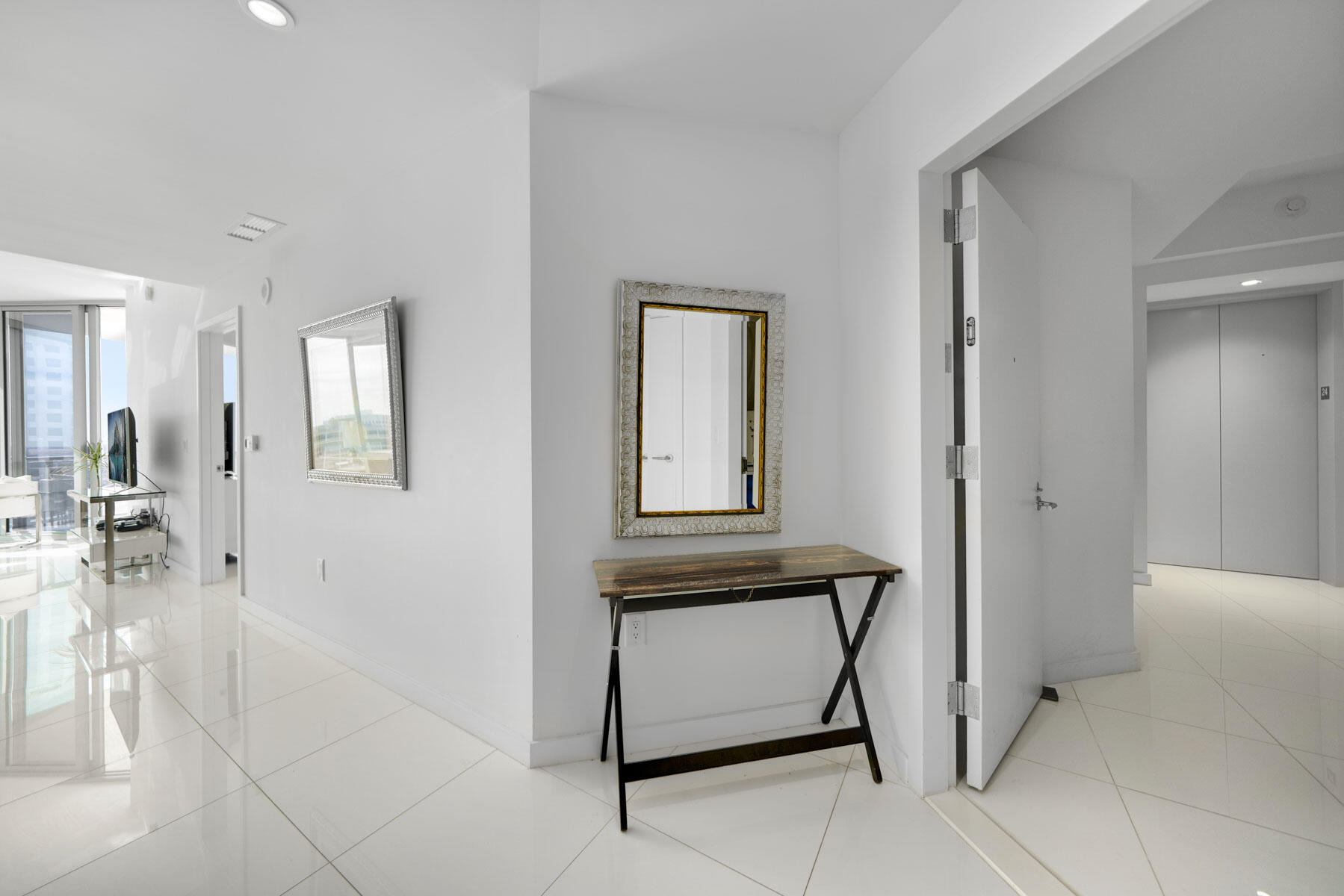 851 Northeast 1st Avenue, Unit 2410 Miami, FL 33132 - Photo 7 of 27 a view of a hallway with dining area and chandelier