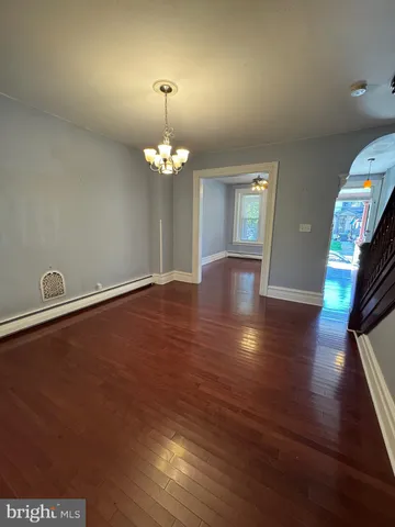 a view of livingroom with hardwood floor and kitchen view
