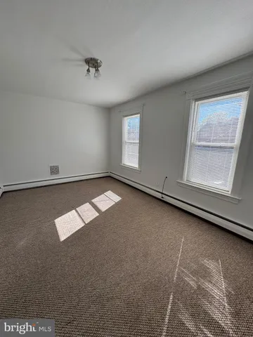 an empty room with a empty space and windows