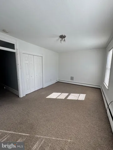 an empty room with a empty space and windows