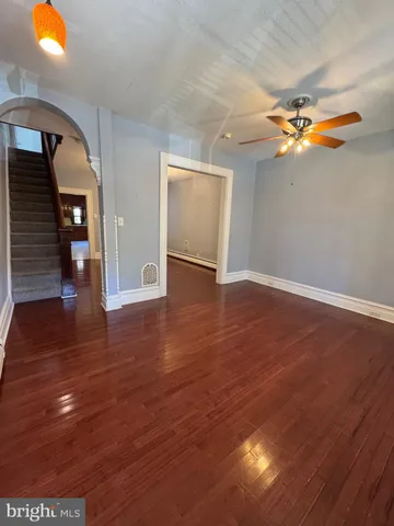 a view of empty room with wooden floor