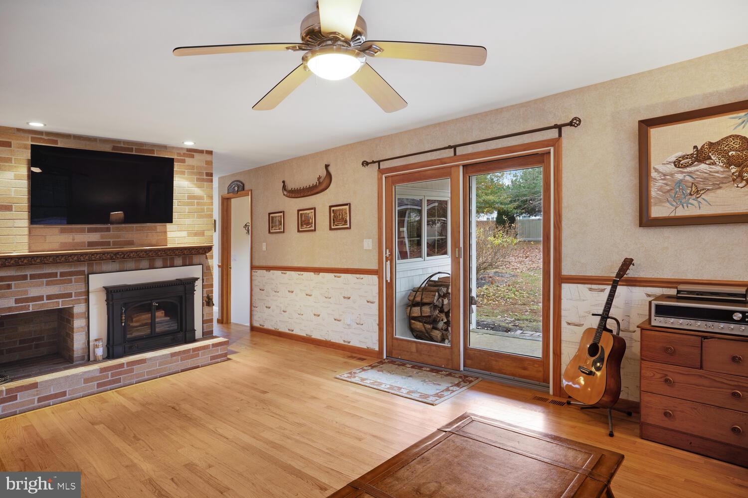 111 Mathis Drive Little Egg Harbor, NJ 08087 - Photo 23 of 38 a view of a livingroom with a fireplace a ceiling fan and windows