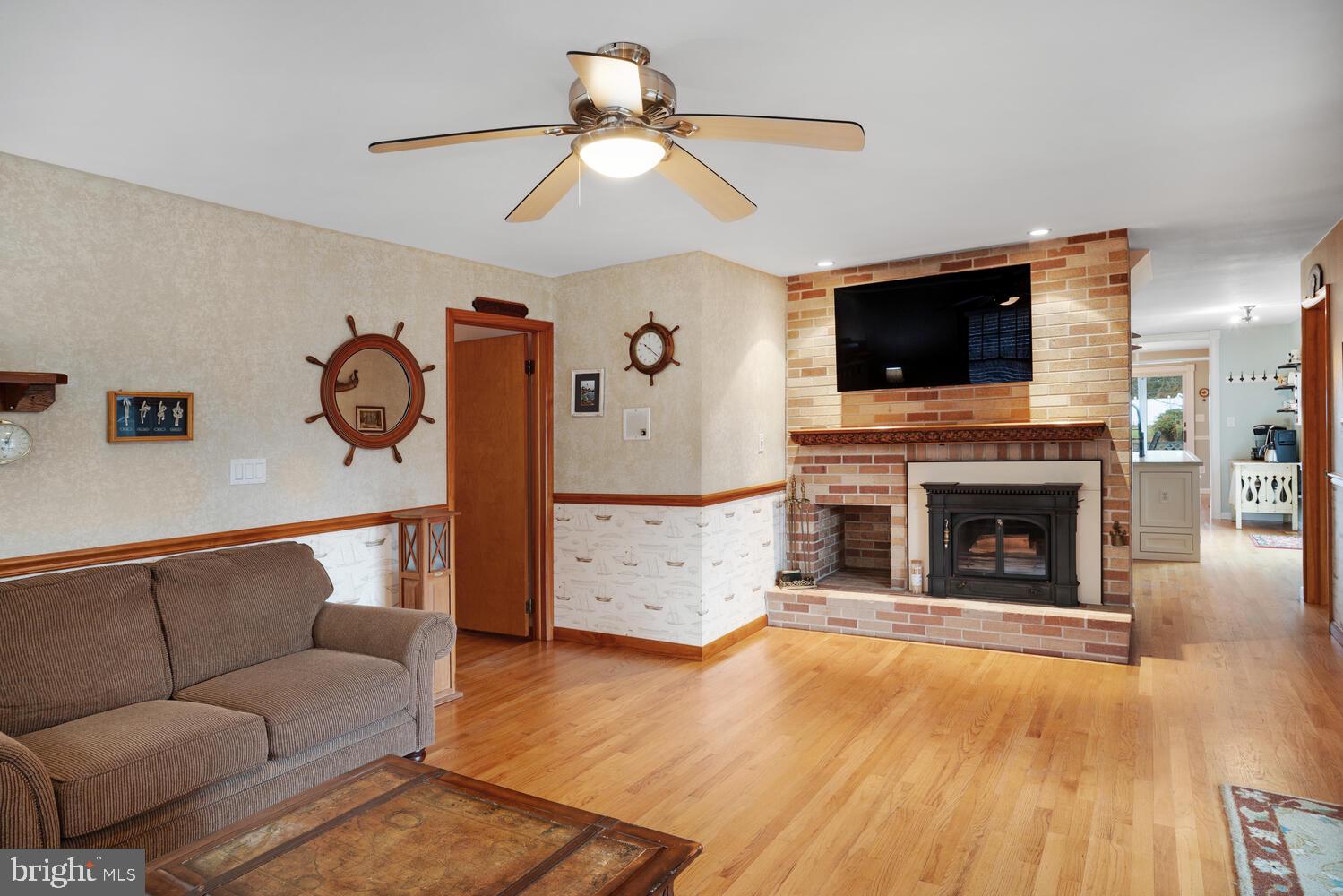 111 Mathis Drive Little Egg Harbor, NJ 08087 - Photo 24 of 38 a living room with furniture a flat screen tv and a fireplace