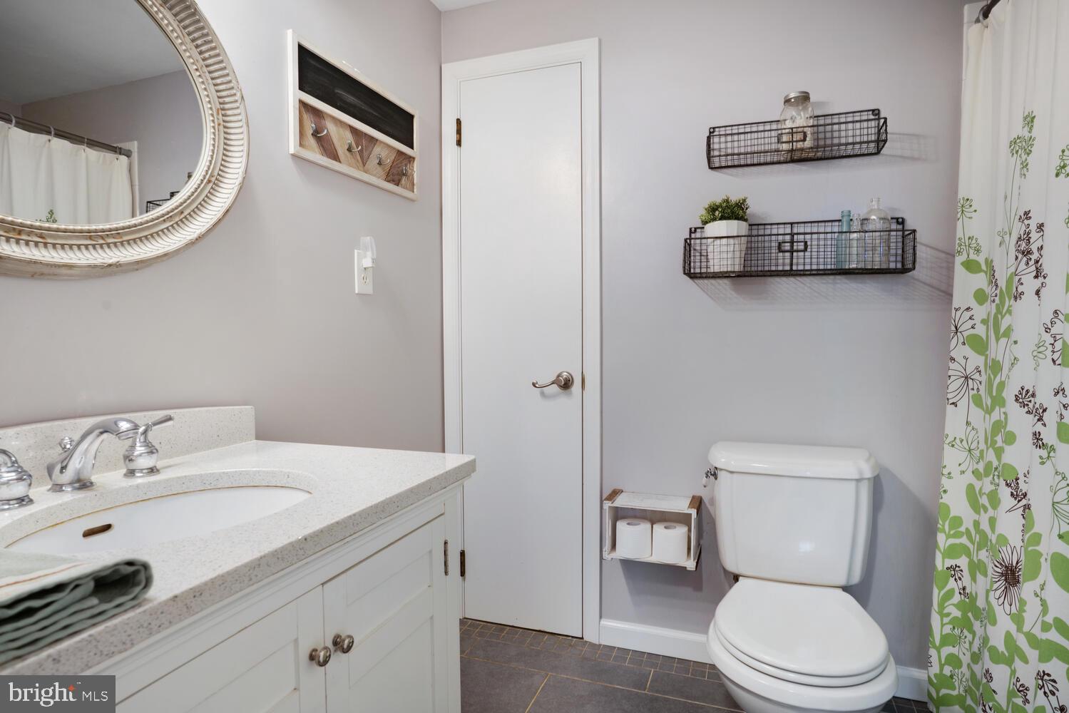 111 Mathis Drive Little Egg Harbor, NJ 08087 - Photo 33 of 38 a bathroom with a toilet a sink and mirror