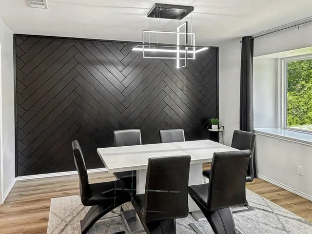 a dining room with a table and chairs