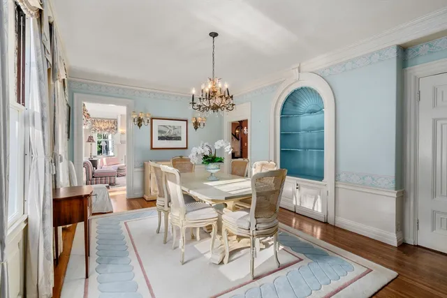 a view of a dining room with furniture and chandelier
