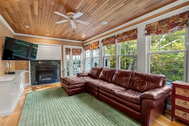a living room with furniture a flat screen tv and a fireplace