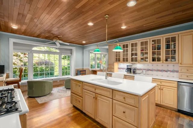 a kitchen with sink stove and cabinets