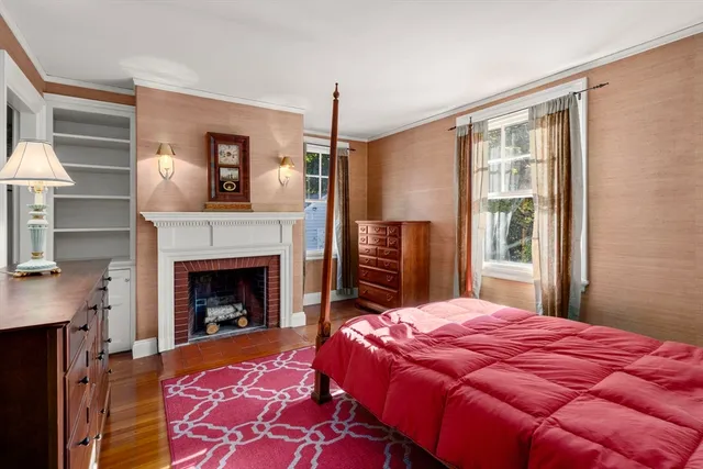 a bedroom with a bed and a fireplace