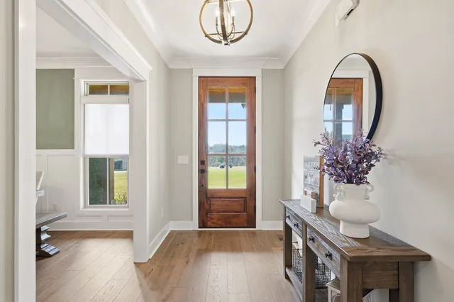 a view of a room with wooden floor and a potted plant