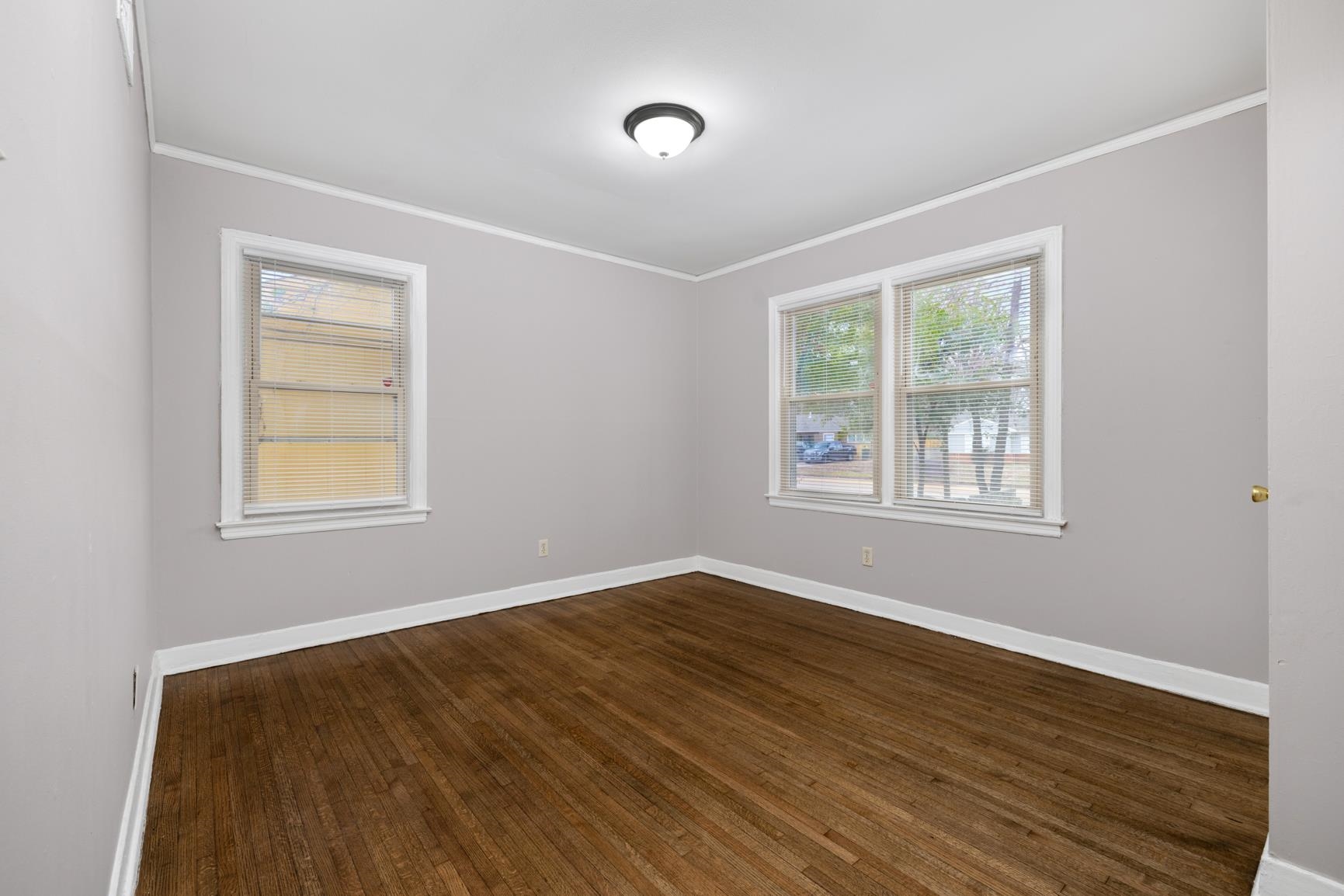 1584 South Perkins Road Memphis, TN 38117 - Photo 15 of 21 Unfurnished room featuring crown molding, baseboards, and dark wood-style flooring
