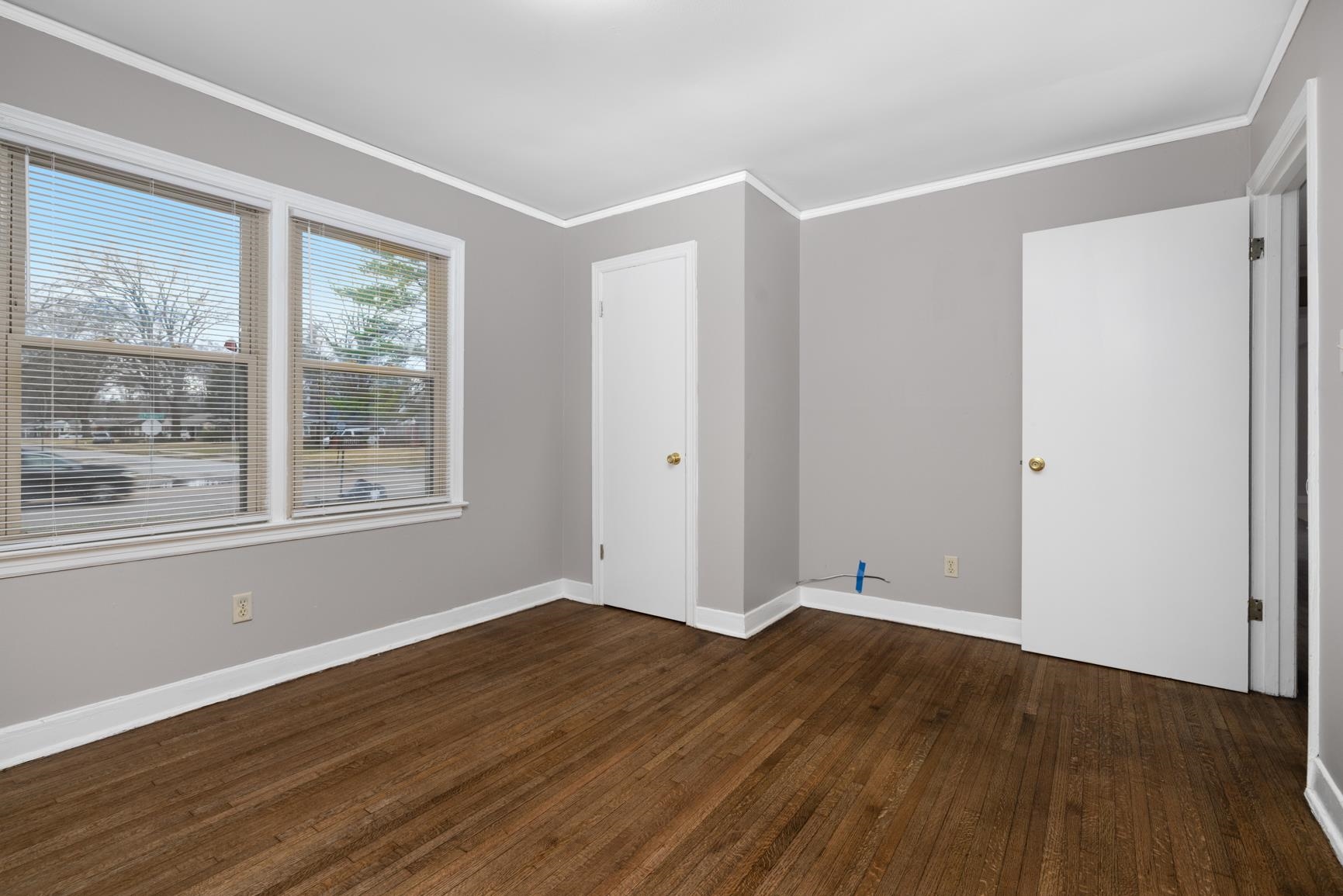 1584 South Perkins Road Memphis, TN 38117 - Photo 16 of 21 Spare room featuring crown molding, baseboards, and hardwood / wood-style floors