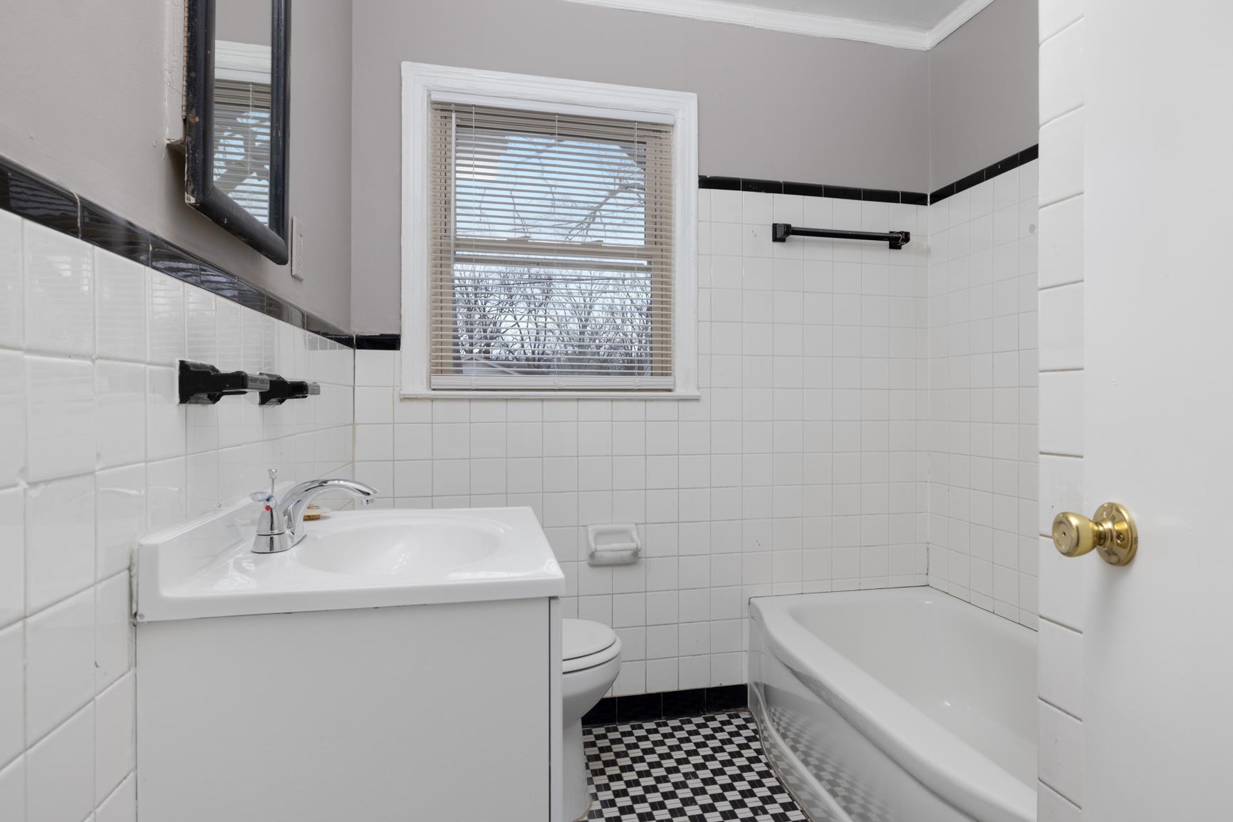 1584 South Perkins Road Memphis, TN 38117 - Photo 17 of 21 Full bath with vanity, crown molding, tile walls, toilet, and a washtub