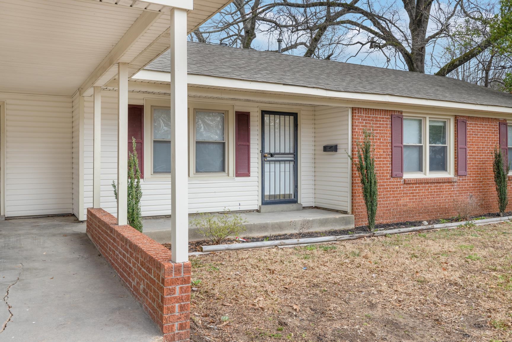 1584 South Perkins Road Memphis, TN 38117 - Photo 3 of 21 Exterior space featuring an attached carport and a shingled roof