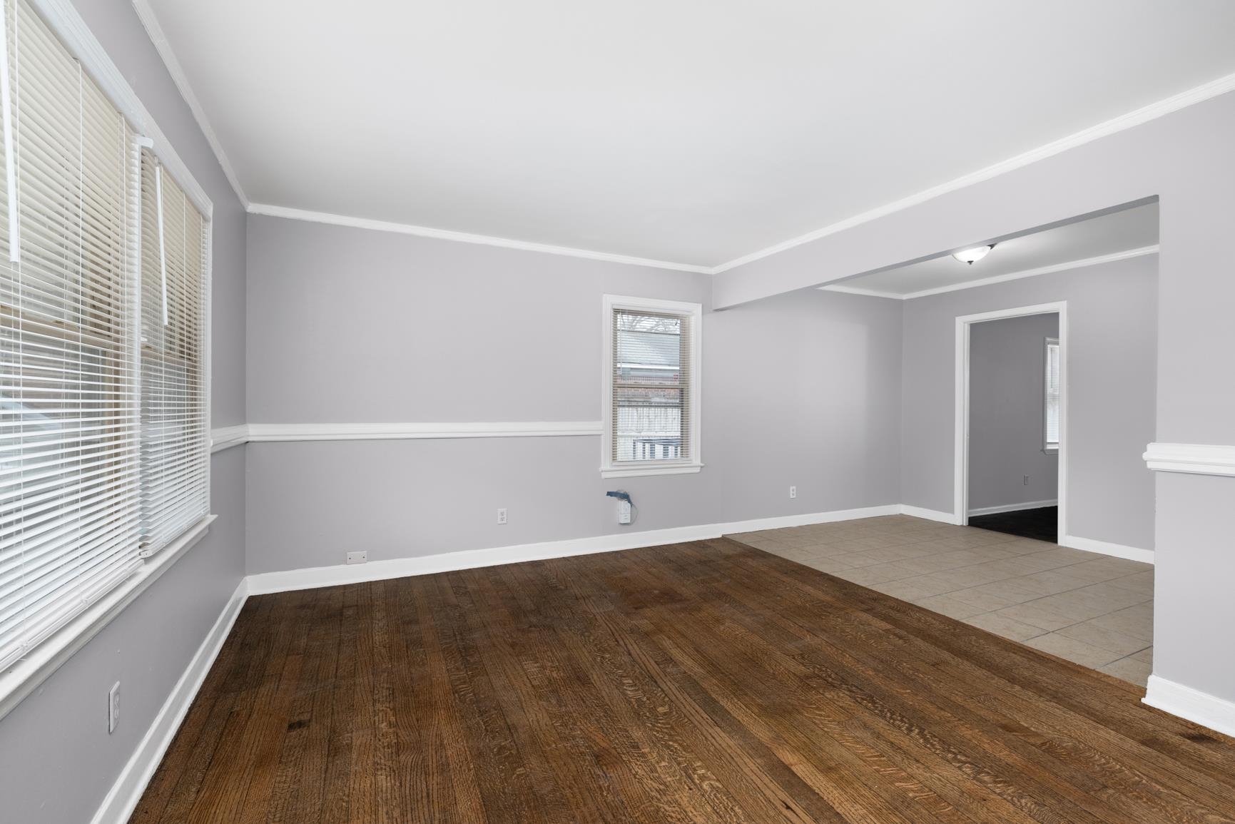 1584 South Perkins Road Memphis, TN 38117 - Photo 5 of 21 Empty room with hardwood / wood-style floors, baseboards, and ornamental molding