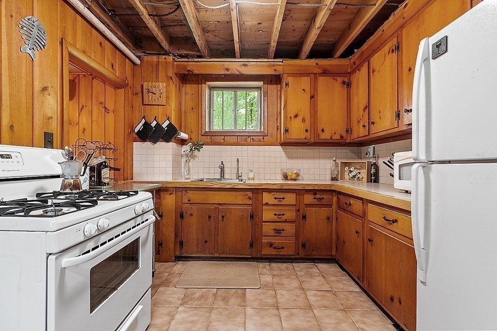 50 Sauna Row Road Townsend, MA 01474 - Photo 8 of 41 a kitchen with stainless steel appliances granite countertop a stove sink and cabinets