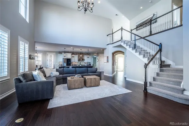 a living room with furniture or wooden floor and a chandelier