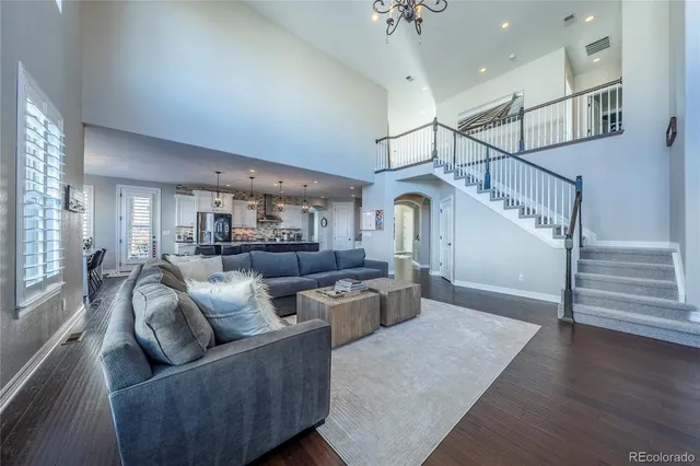 a living room with furniture or wooden floor and a chandelier